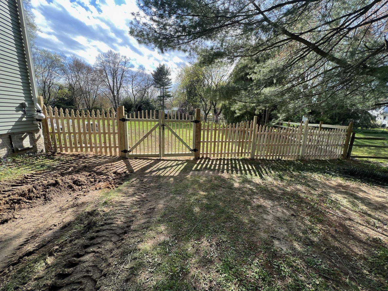 Wood fence upgrade showing reinforced posts and new boards